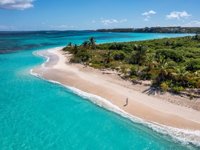 Aerial,View,A,Woman,Walking,Along,The,Beach,Of,Shoal
