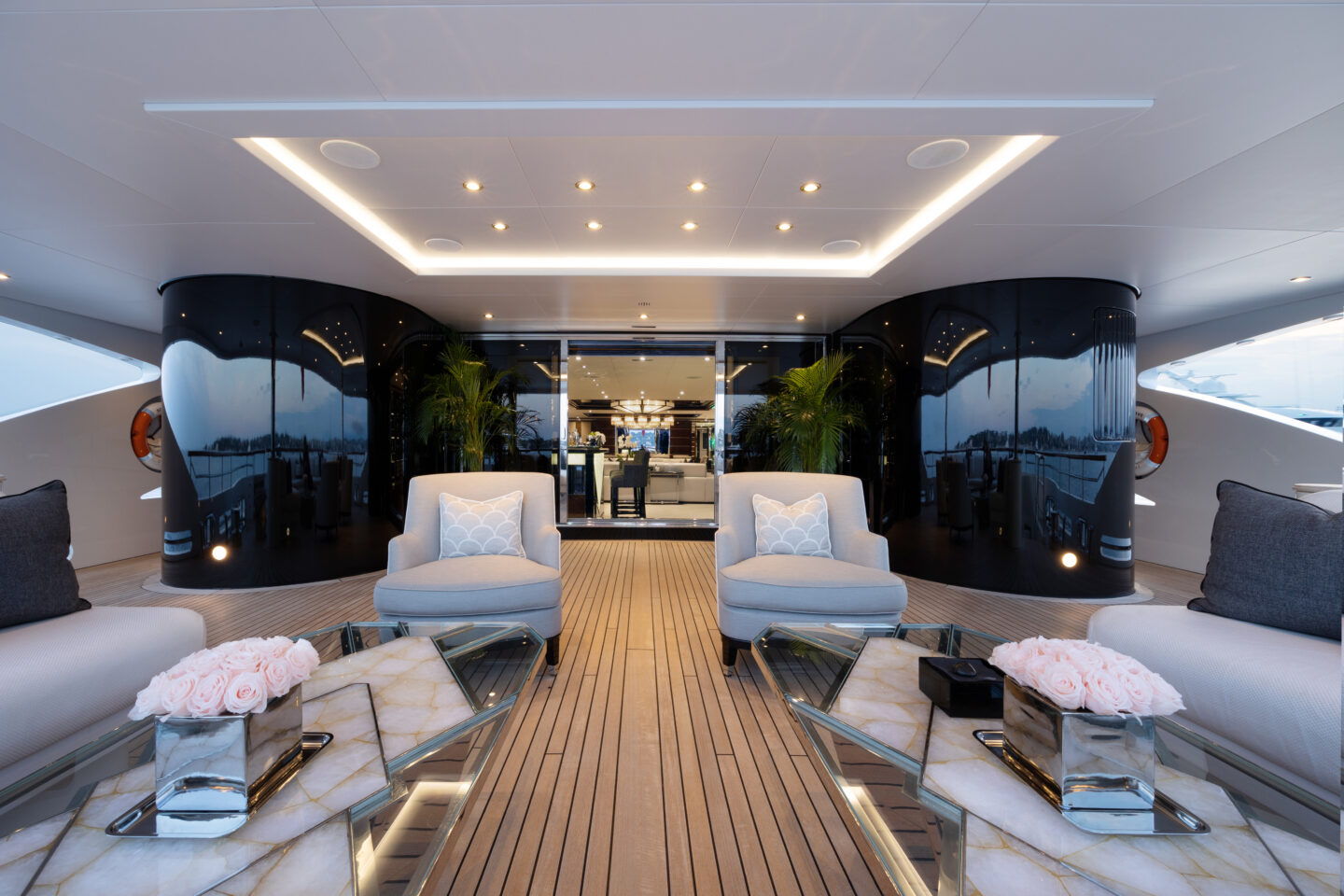 M/Y Soundwave for charter aft deck with plush sofas and outdoor lounge seating. Credit: Roccabella / Malcorps.