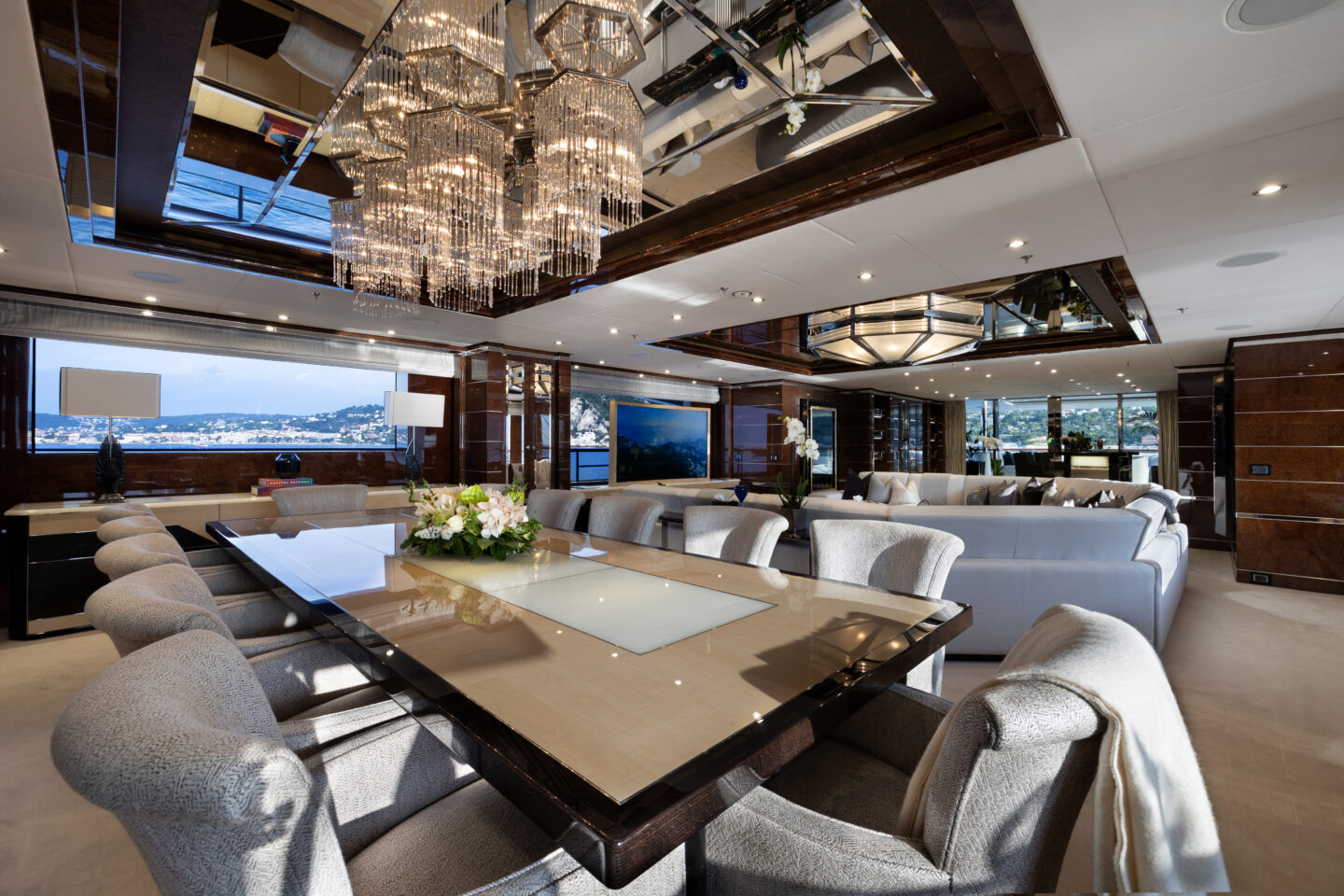 M/Y Soundwave for charter main salon with elegant dining area and lounge. Credit: Roccabella / Malcorps